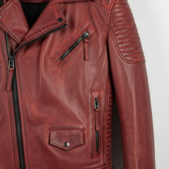 detail of zip pockets and flap pocket on men's red leather biker jacket.