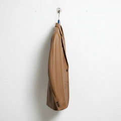 Side profile of men’s tan leather blazer jacket