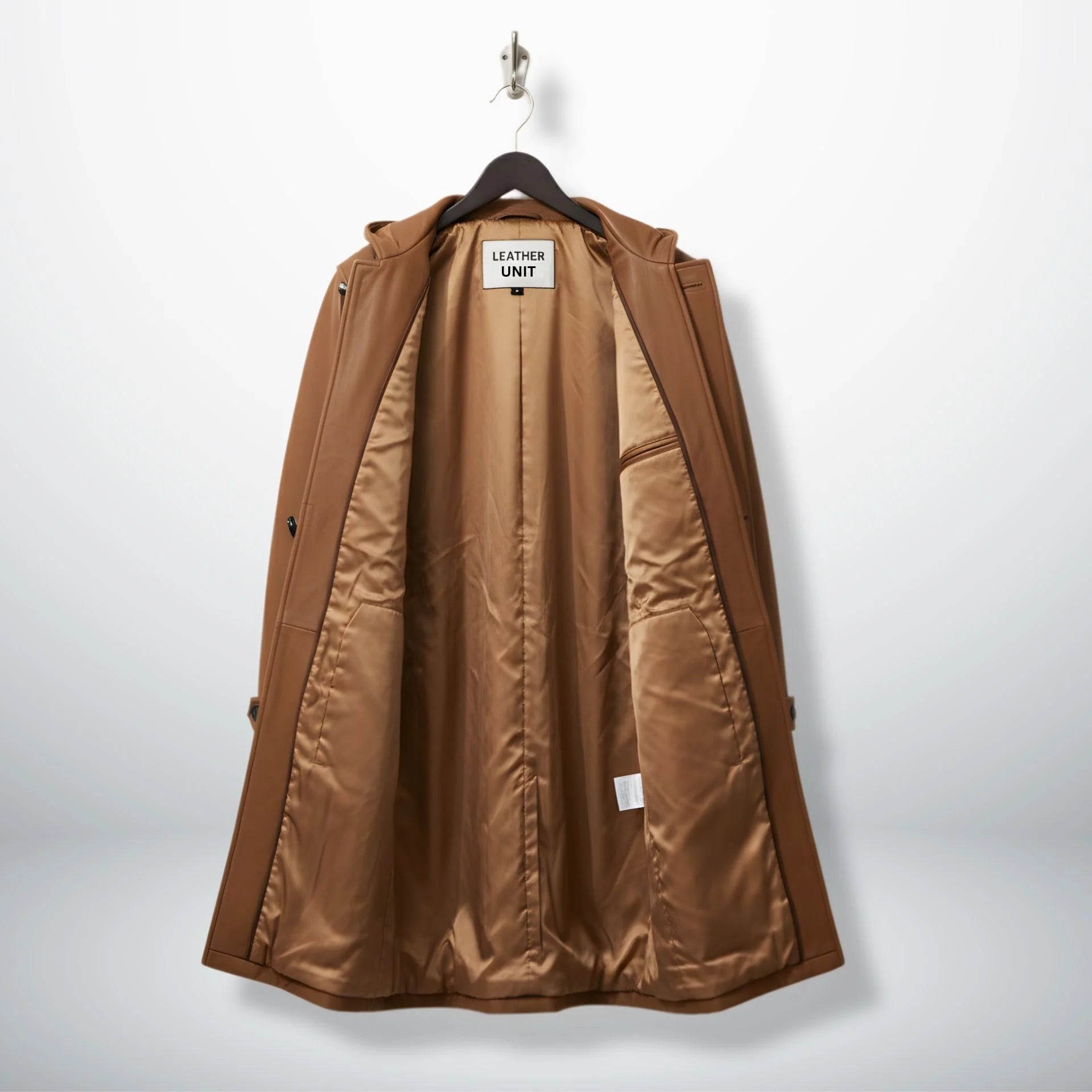 Interior of men's tan leather duffle coat showing smooth lining and inside pockets.