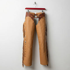 Front view of men's tan leather western fringe chaps with tooled brown yoke