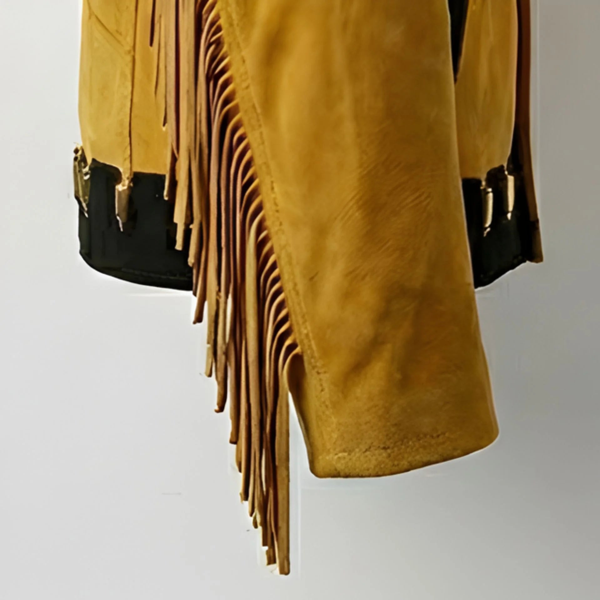 Detail of long sleeve fringe on men's tan suede western jacket.
