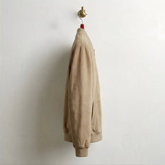 Side profile of men's tan suede bomber jacket with clean slim fit.