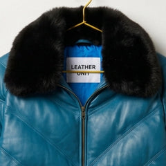 Close-up plush black fur collar on men's teal leather V-bomber jacket