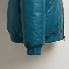 Detail of snap rib-knit cuffs on insulated teal leather jacket