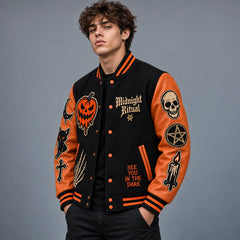 Three-quarter view of black and burnt orange occult varsity jacket showing embroidered front and sleeve patches