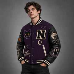 Three-quarter view of purple gothic varsity jacket showing cat, moon, bat, lantern and graveyard sleeve artwork