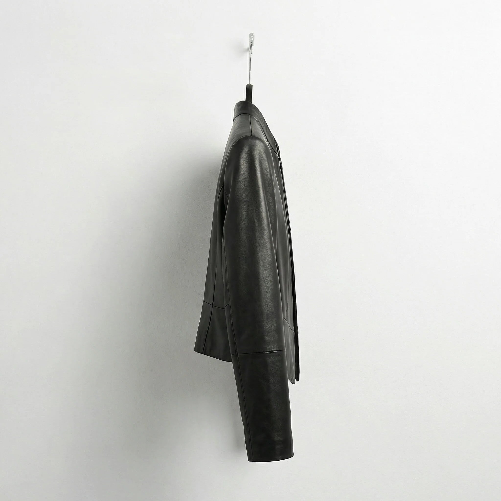 Side view of womens open front black leather blazer style jacket