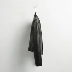 Side view of womens open front black leather blazer style jacket