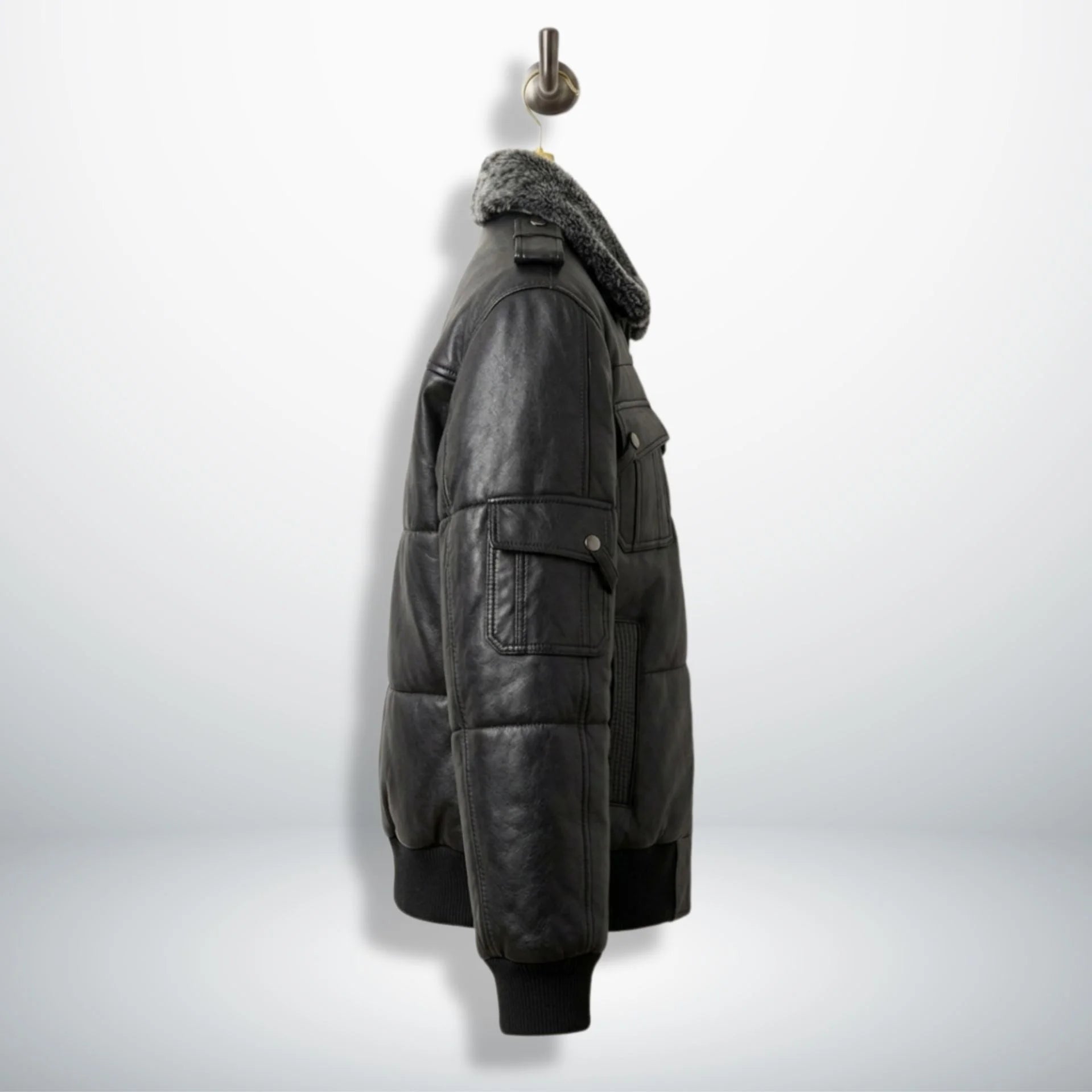 Side profile of men's black leather puffer bomber jacket with sleeve pocket