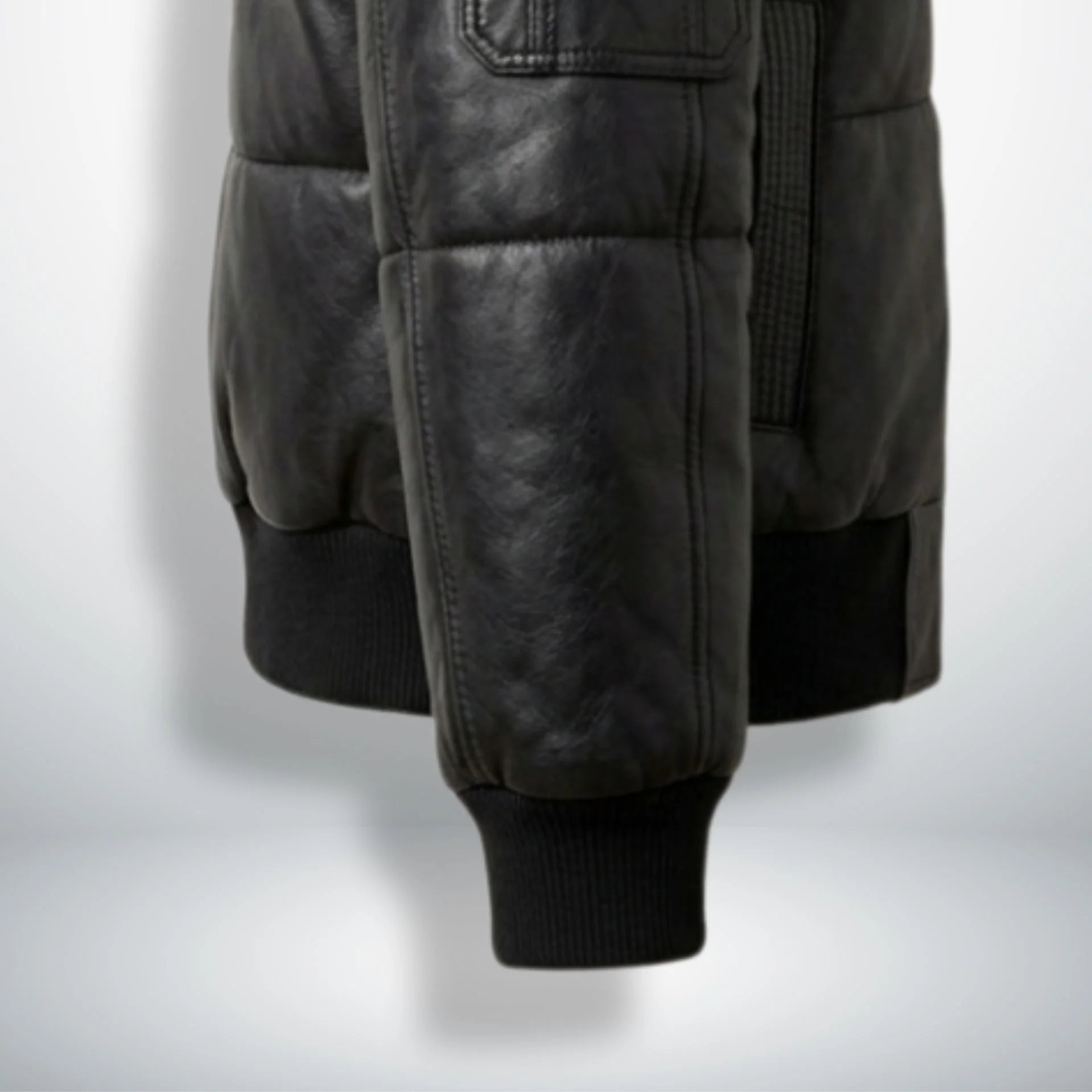 Close-up of ribbed cuffs and waistband on black puffer leather jacket