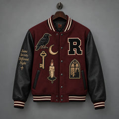 Front hanging view of Raven Manor varsity jacket with black leather sleeves, raven patch and gothic window design
