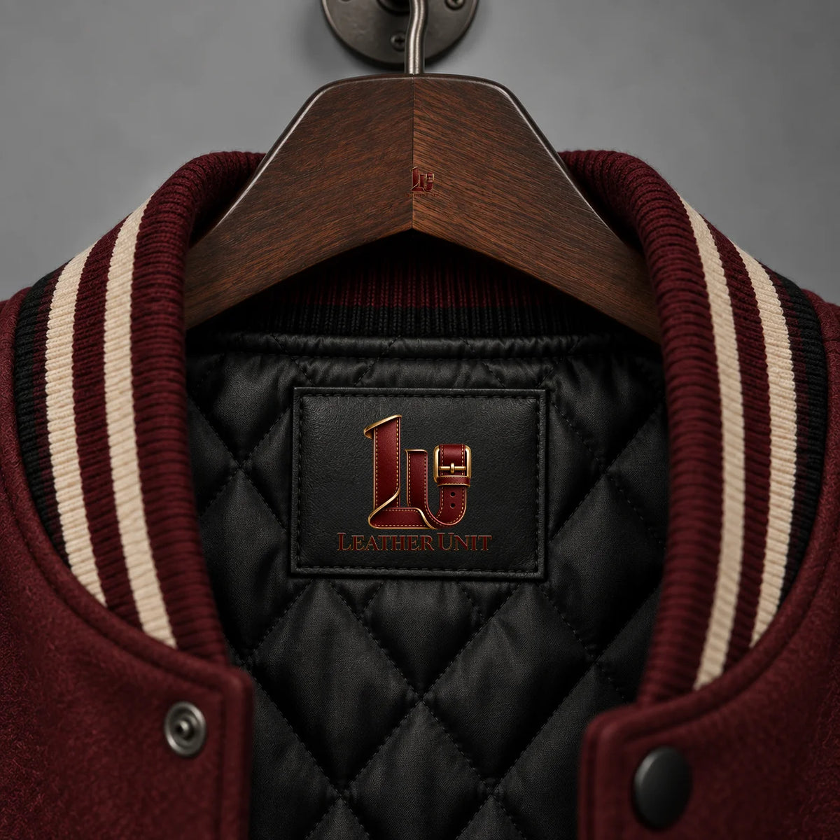 Close-up of Raven Manor varsity jacket black quilted lining and burgundy black cream striped rib collar