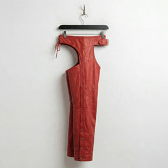 Side profile of red leather motorcycle chaps with snap leg closures