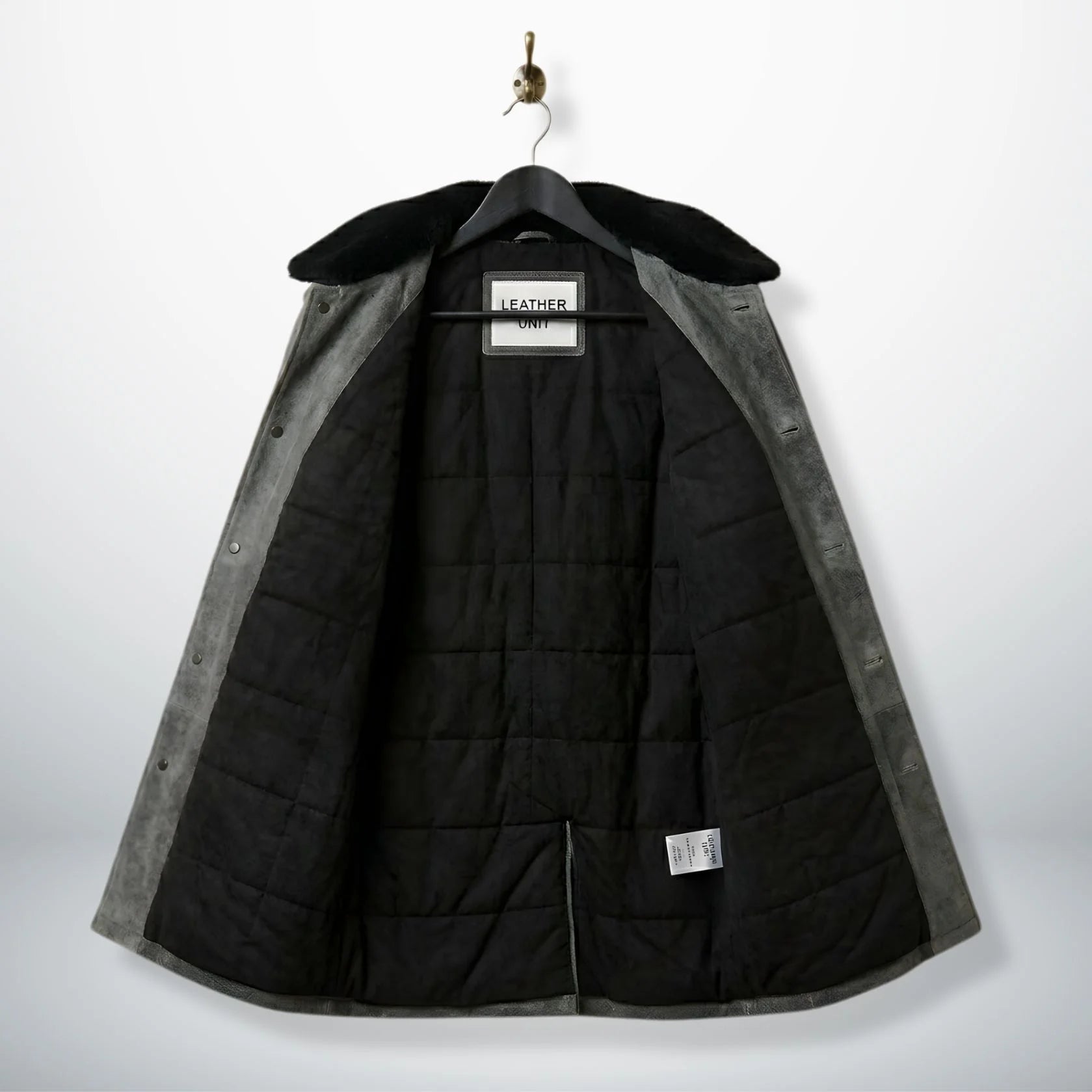 inside view mens grey leather coat showing black quilted lining.