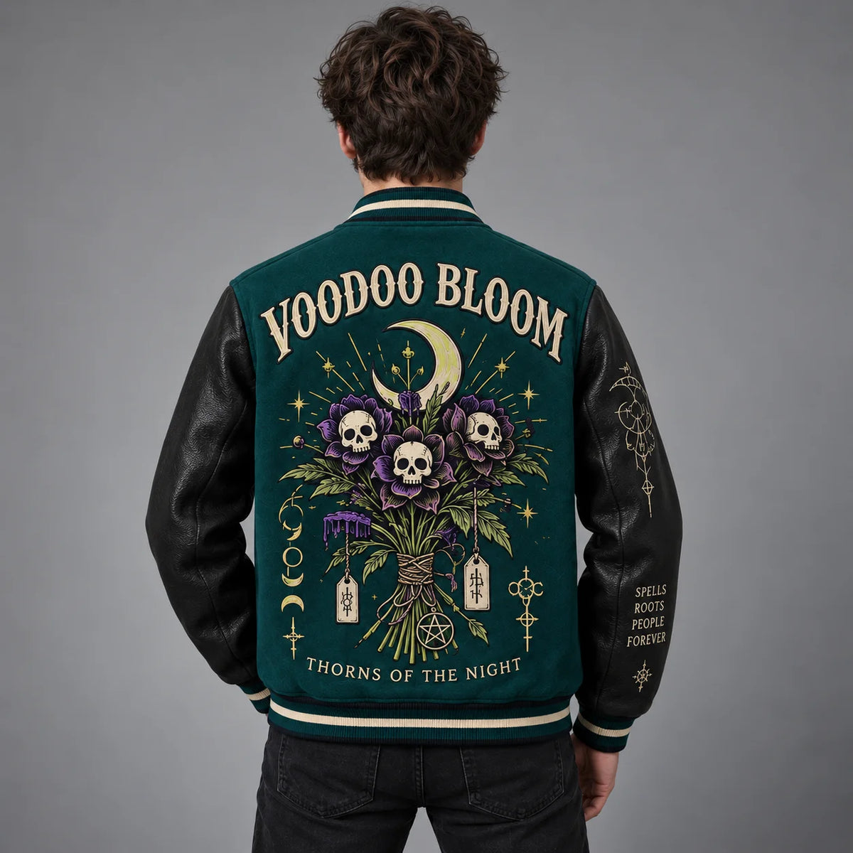 Back studio view of Voodoo Bloom varsity jacket with skull flowers, crescent moon and embroidered gothic artwork