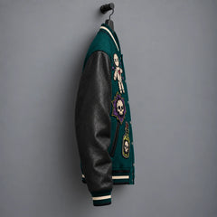 Side profile of deep teal varsity jacket highlighting textured black genuine leather sleeve and embroidered front