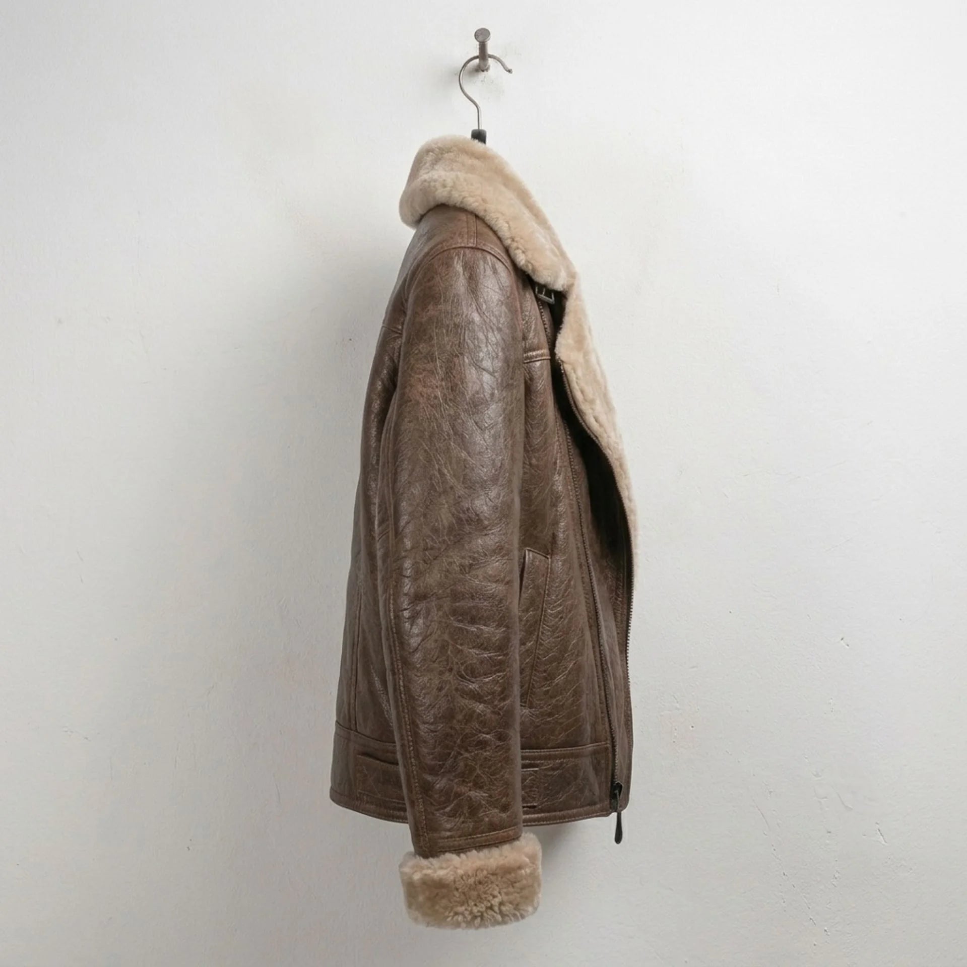 Side profile of women’s brown shearling aviator leather bomber jacket