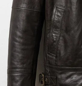 Waist pocket and leather texture close-up on women’s brown bomber jacket