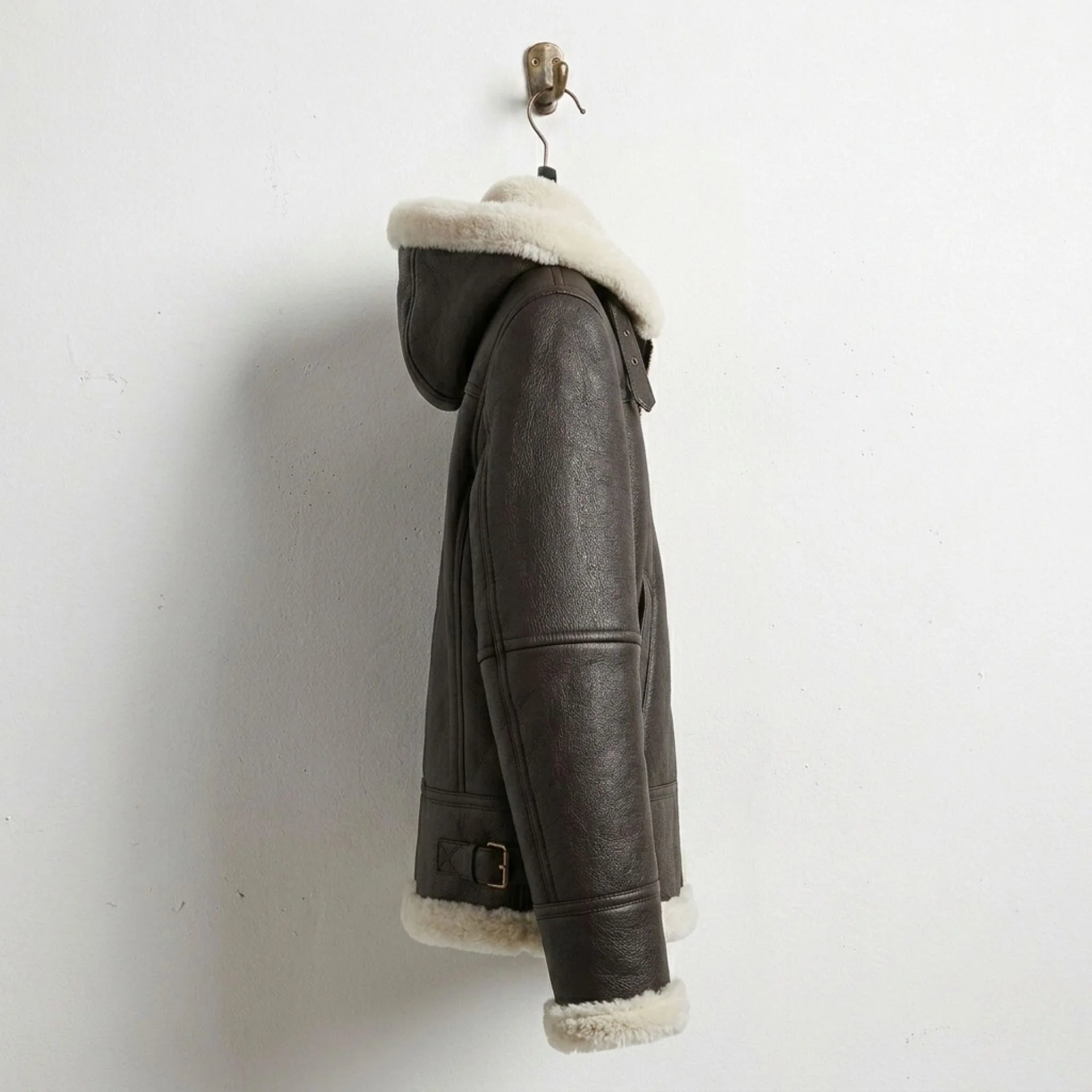 Side profile of women’s brown shearling hooded leather bomber jacket