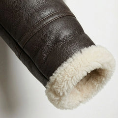 Close up of shearling cuff on women’s brown aviator leather jacket