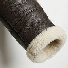 Close up of shearling cuff on women’s brown aviator leather jacket
