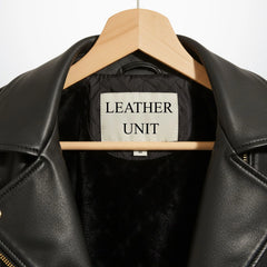 close up collar and label on womens black leather biker jacket leather unit.