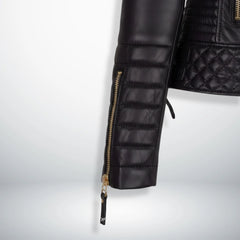 close up padded sleeve and zipper cuff on womens black motorcycle jacket.