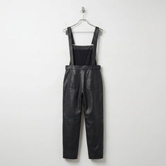 Back view of women’s black leather overalls showing rear pockets