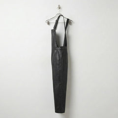 Opposite side view of women’s black leather dungarees
