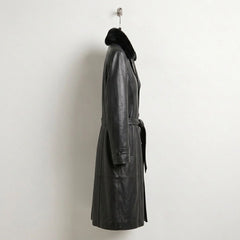 Side profile of women’s knee length black leather trench coat