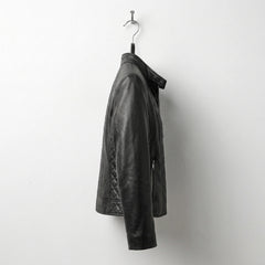 Side profile of women’s black quilted leather moto jacket