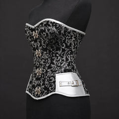Three-quarter product view of black silver corset highlighting silver faux leather side panel and buckle accent