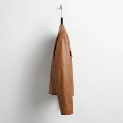 Side profile of women’s brown lambskin collarless leather jacket