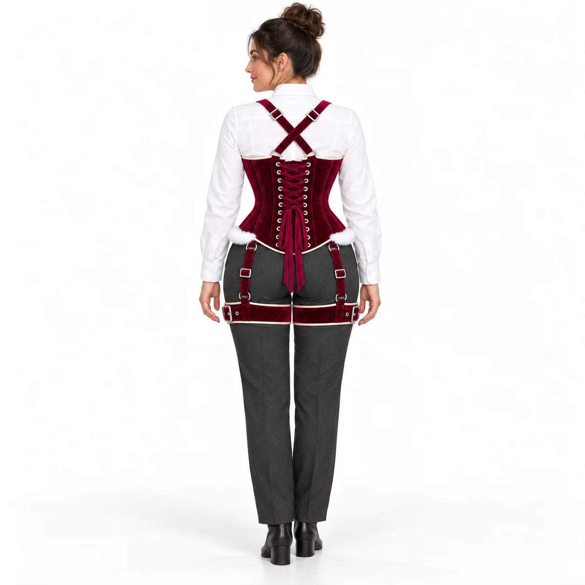 Back view of woman wearing a burgundy velvet corset with adjustable lacing, crossed shoulder straps and matching thigh harness.