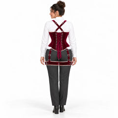Back view of woman wearing a burgundy velvet corset with adjustable lacing, crossed shoulder straps and matching thigh harness.