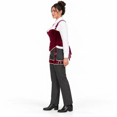Full-length side view of woman wearing a burgundy velvet corset harness with adjustable thigh bands over grey tailored trousers.