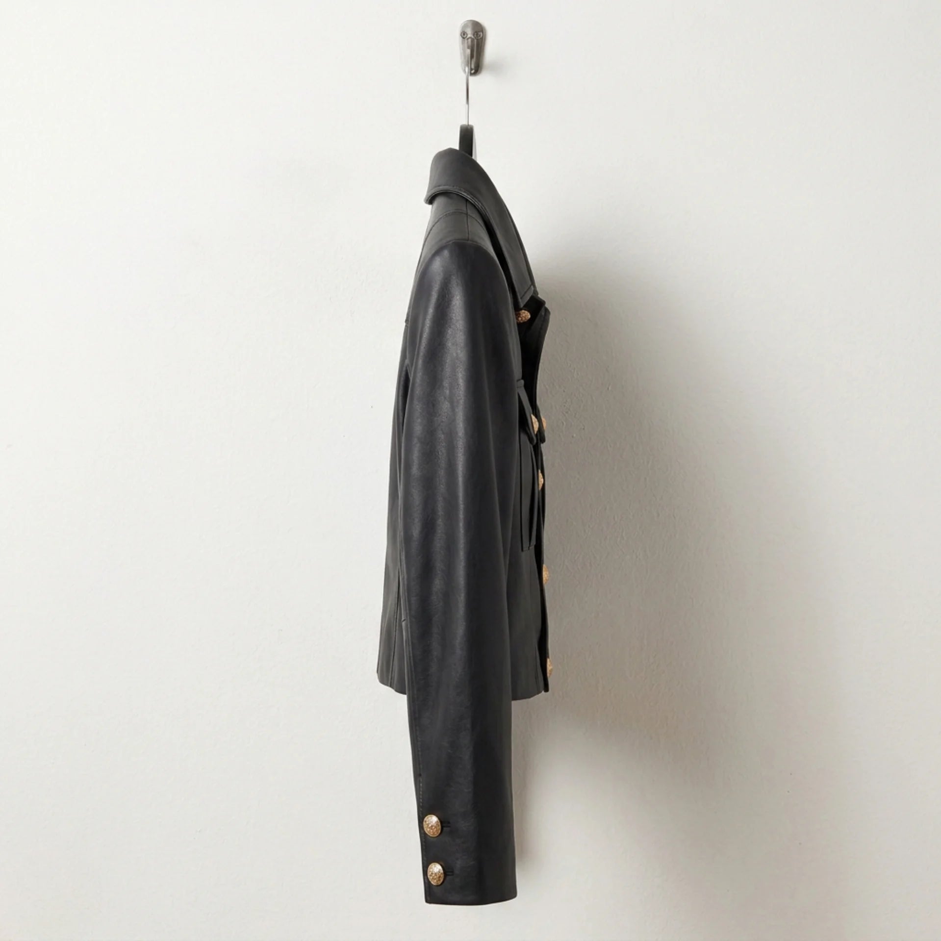 Side profile of cropped women’s black military leather jacket