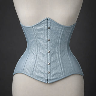 Front mannequin view of pale blue-grey underbust corset with reptile-effect texture, vertical seams and busk closure.