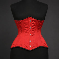 Front studio view of red satin underbust corset showing vertical boning channels and busk-style fastening