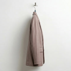 Side profile of women’s taupe single button leather blazer