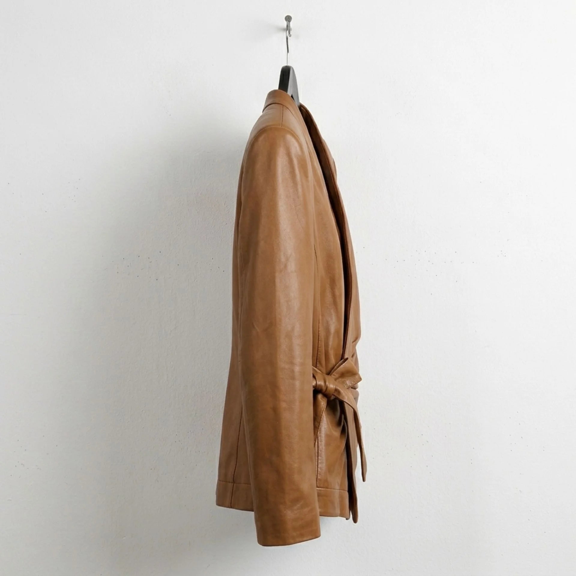 Side view of womens V neck wrap leather blazer with waist tie
