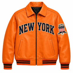 Front view of orange Avirex inspired leather bomber jacket with large New York lettering, zip closure and striped rib-knit trims