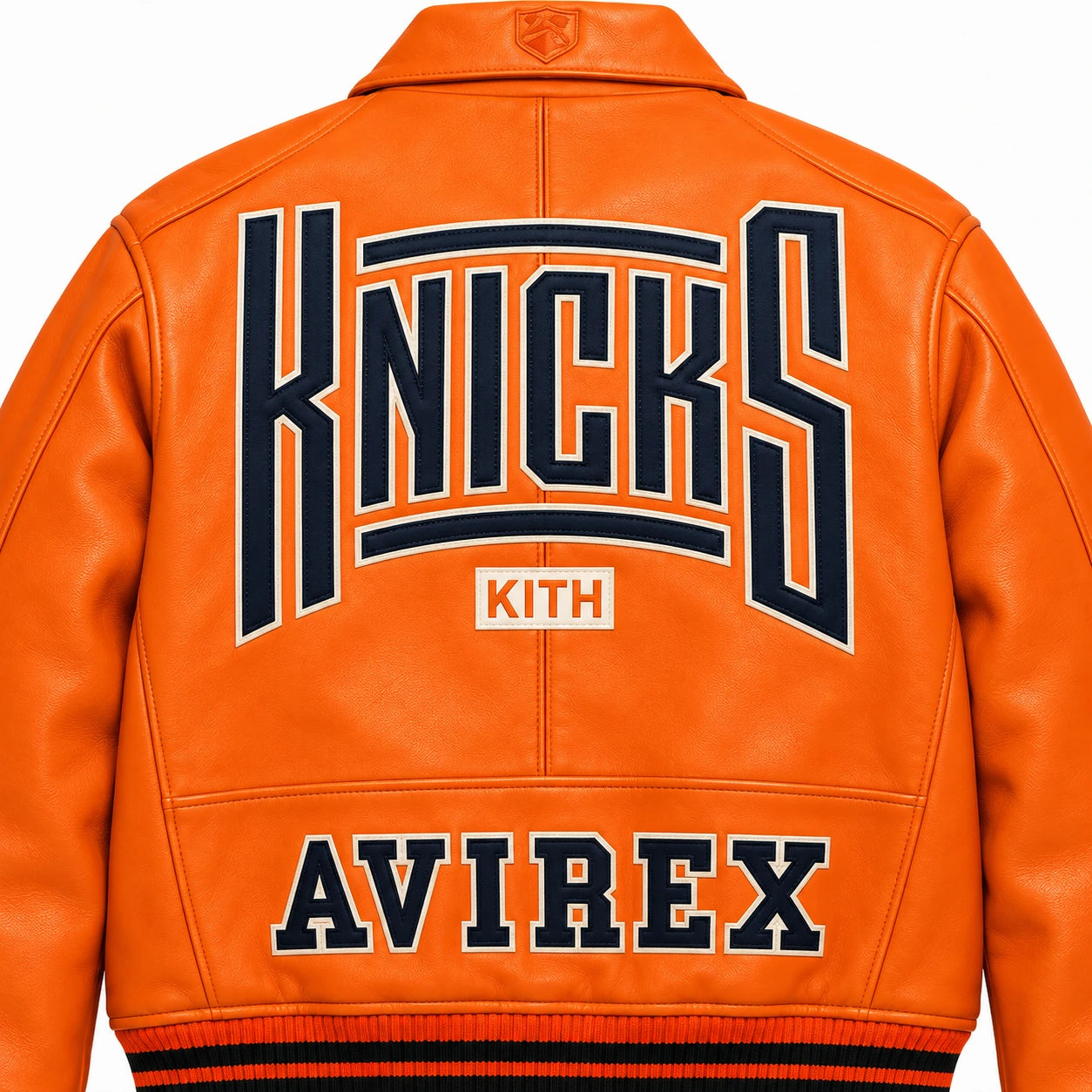 Close-up back view of orange leather bomber showing oversized Knicks graphic with Kith and Avirex lettering