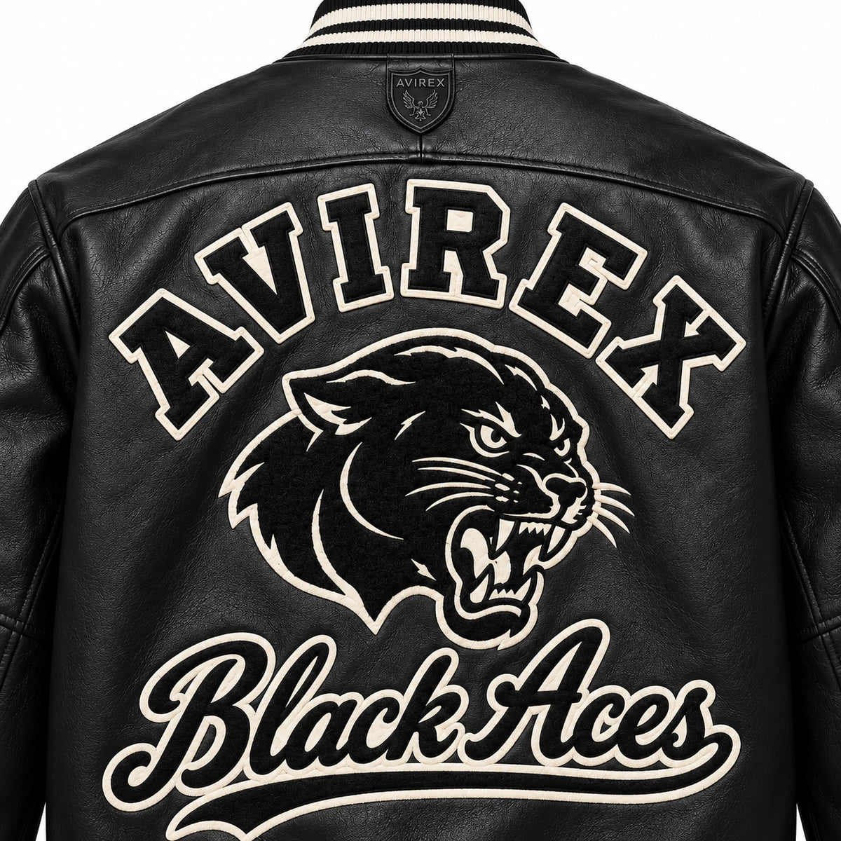 Close-up back view of Avirex Black Aces leather jacket showing oversized AVIREX lettering, panther graphic and cream script