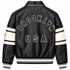 Full back view of Avirex men’s black leather bomber featuring large BROOKLYN USA lettering and cream sleeve panels