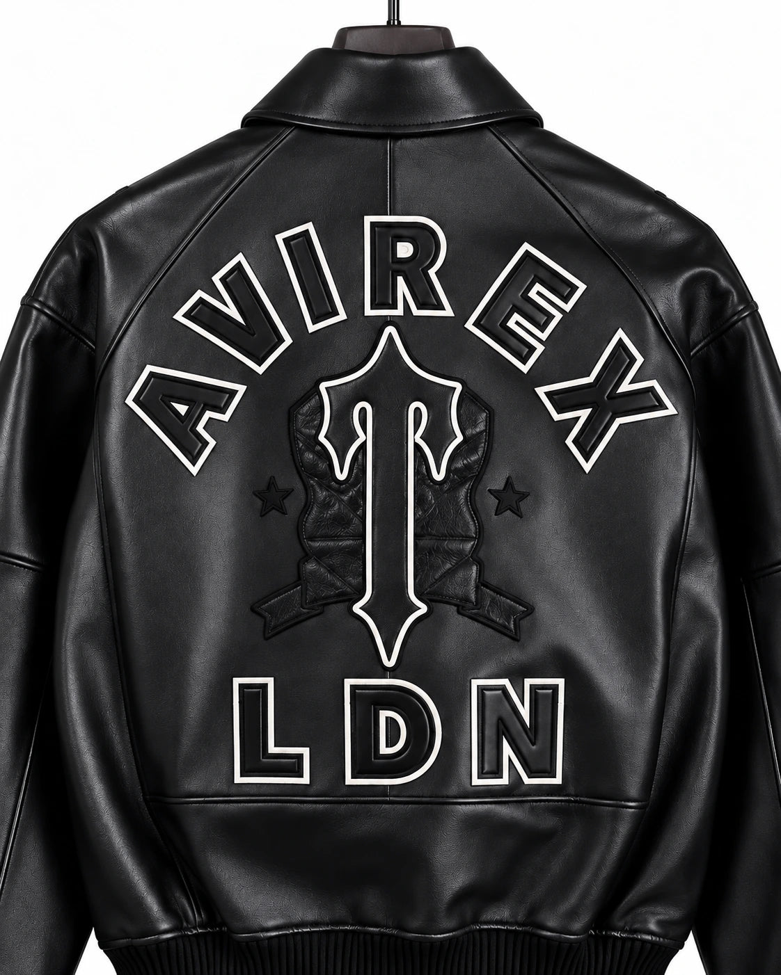 Close-up rear detail of Avirex black leather bomber showing AVIREX lettering, outlined central emblem, stars and LDN logo
