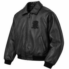 Three-quarter front view of Avirex men’s black leather bomber with tonal chest crest, zip closure and rib-knit cuffs