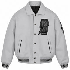Front view of Avirex grey leather varsity jacket with snap-button closure, chest graphic, vertical pockets and striped trims