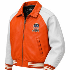 Three-quarter front view of Avirex orange leather bomber with white sleeves, heritage chest patch, zipper and striped cuffs