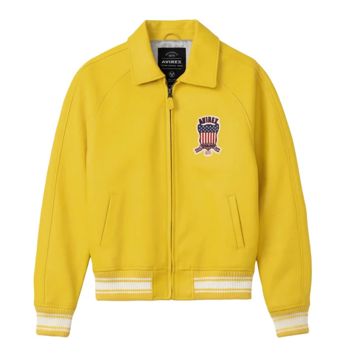 Front view of Avirex men’s yellow leather varsity bomber with chest shield patch, front zip and striped rib-knit trims